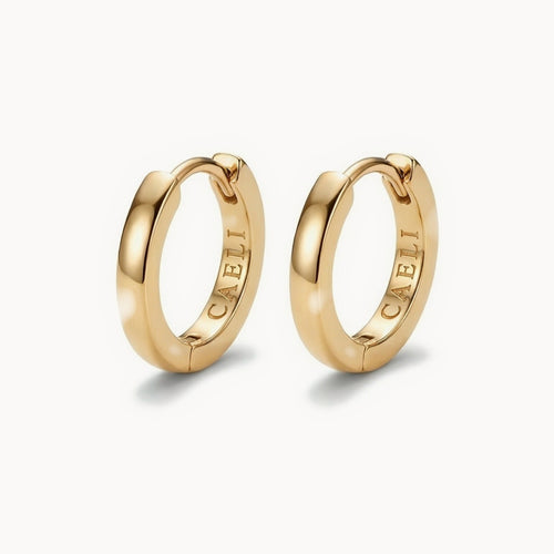 Daylight Huggies, a pair of 16mm gold huggie hoops with a flat-faced squared band and CAELI engraved inside, 14K gold over 316L surgical steel