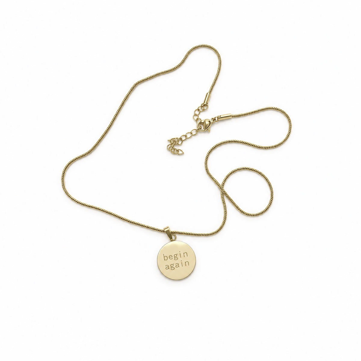 Origin Disc Necklace, a round gold disc pendant engraved begin again on a gold snake chain with extender, Caeli Jewelry