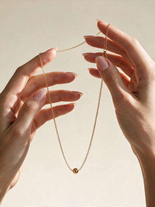 Whisper Chain Necklace dainty gold chain on neutral background, Caeli Jewelry hypoallergenic 316L surgical steel