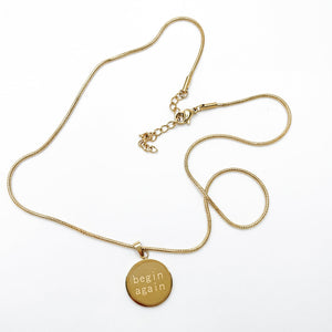 Origin Disc Necklace engraved begin again coin pendant 14K gold plated 316L surgical steel hypoallergenic Caeli Jewelry limited edition